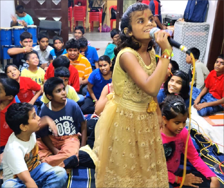 A young girl enthusiastically showcasing her talent.