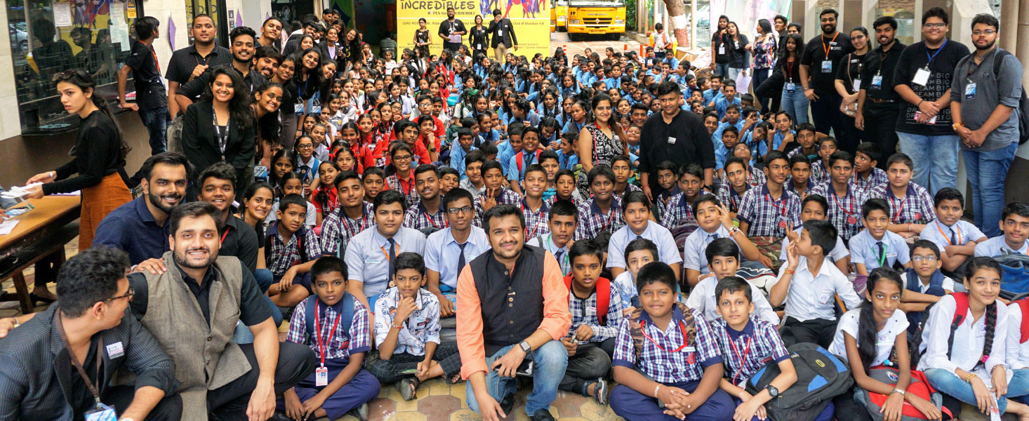 DRR Kushal Bhuva (centre) with schoolchildren and Rotaractors at the RYPEN workshop.