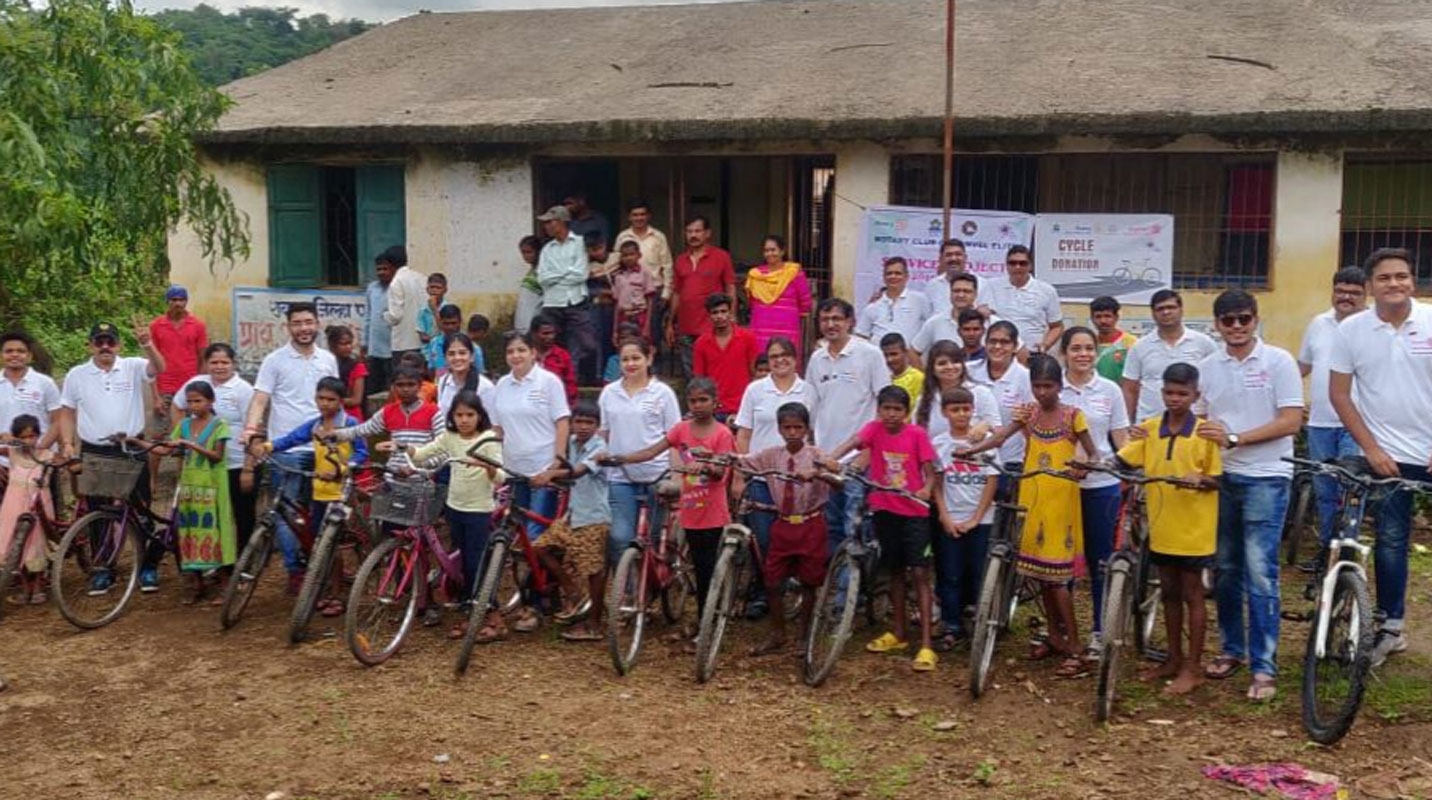 Rotaractors along with tribal children at a cycle distribution project in Sindhalachiwadi village.