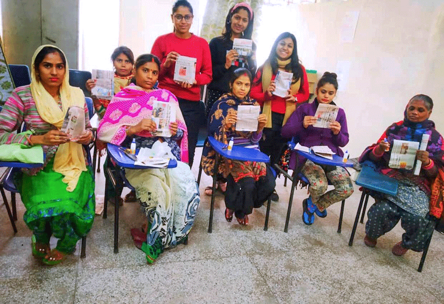 Women holding paper bags at Project Parwaaz.