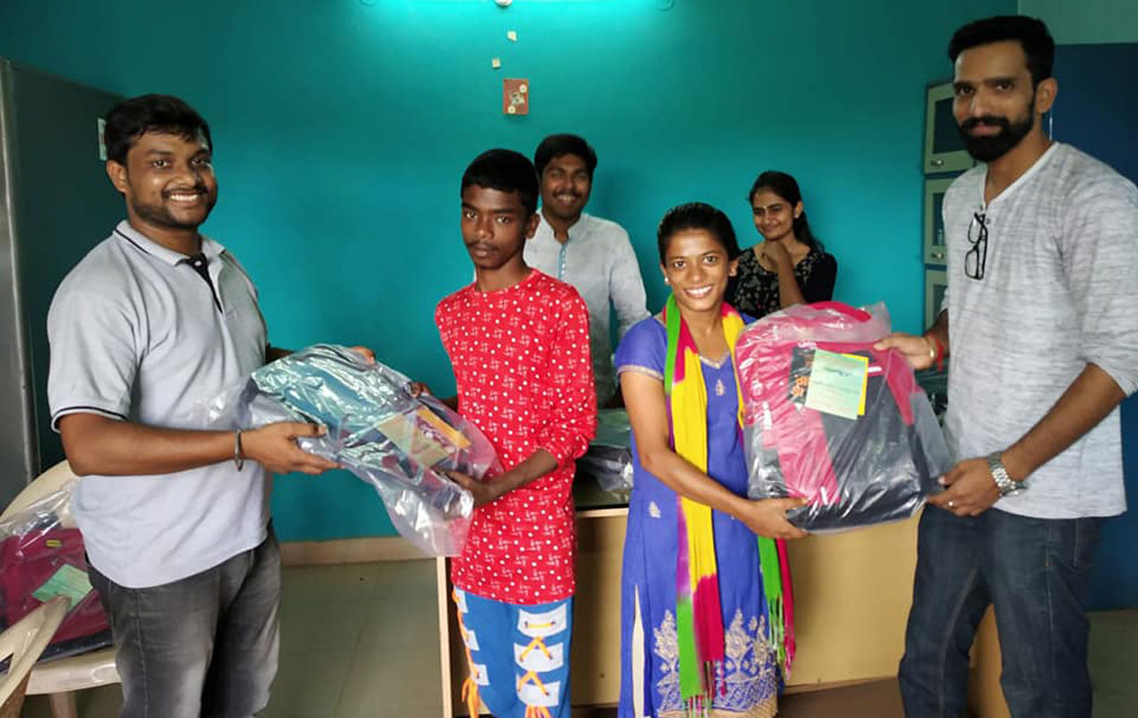 DRR (2019-20) Vinod Kumar Ameti (left) giving schoolbags to inmates of Desire Society.