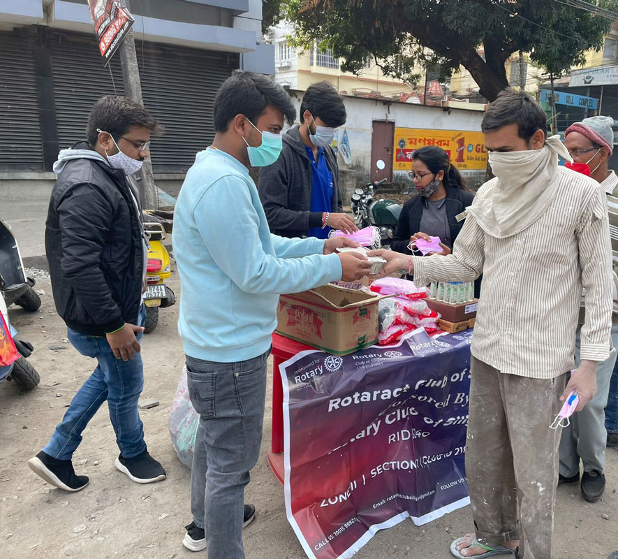 Rotaractors of RAC Siliguri distributing masks and sanitisers.