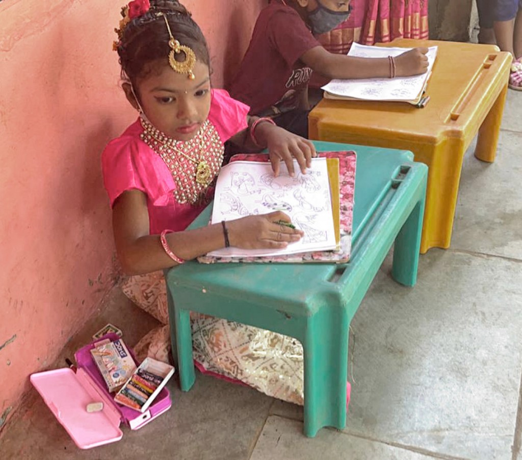 A young participant in a colouring competition organised by the club. 