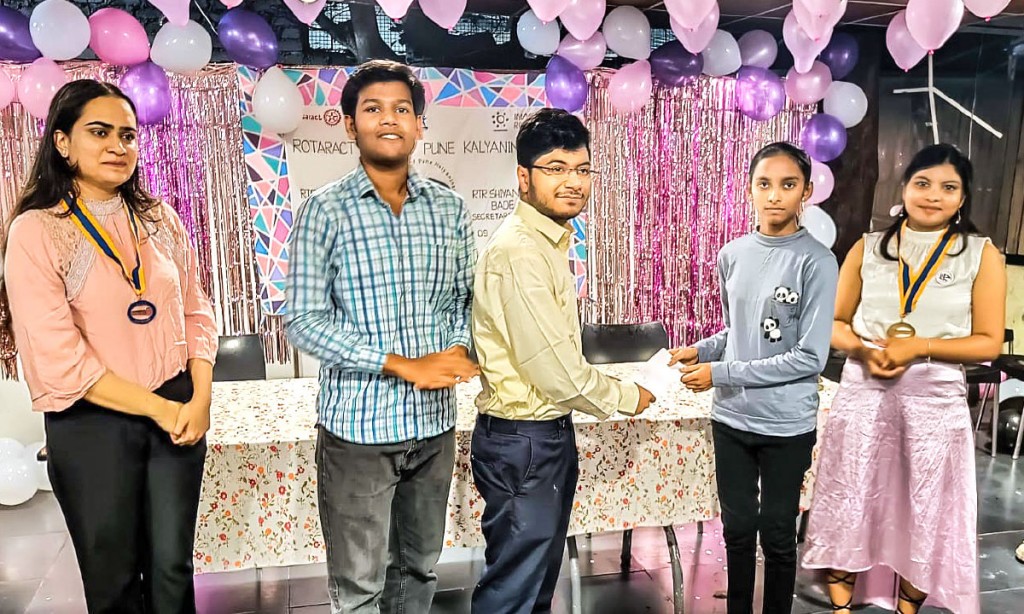 Rtr Sayan Sadhukhan gives a cheque to a child in the presence of (from R) club president Shraddha Sonawane, Rtr Shrungal Kulkarni and club secretary Shivanjali Bade during the club’s Charter Day.