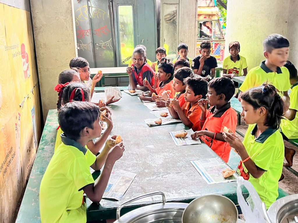 Children enjoying snacks provided by the club under Project Dabbawala.