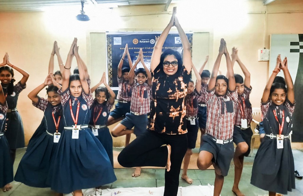A yoga session in progress at a school, as part of the club’s Project Chairoscuro.