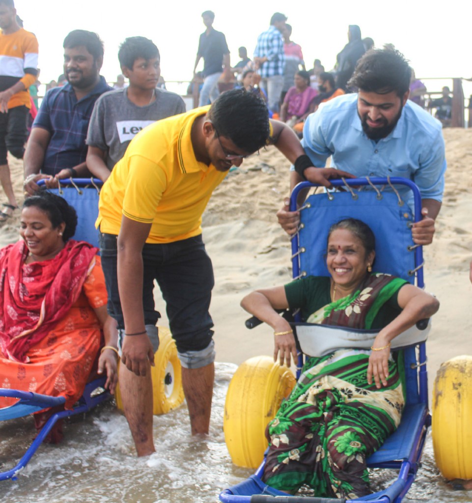 Rotaractors helping wheelchair-bound people to enjoy at the Marina beach in Chennai. 