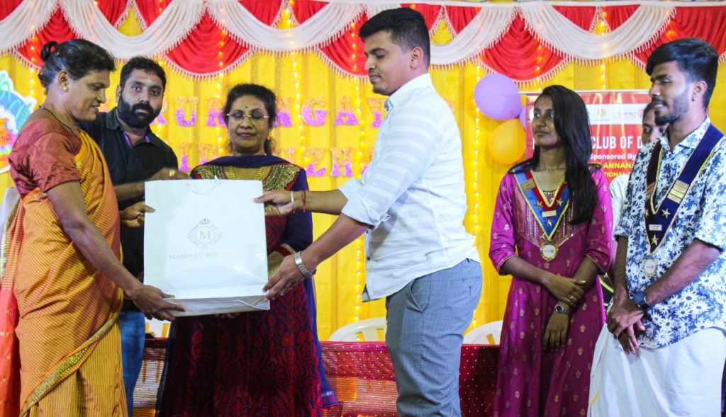 A transgender receives a sari as part of the Pongal celebrations organised by the club. 