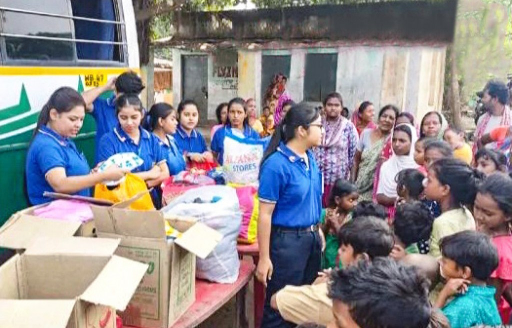 Rotaractors distribute new and sparingly used clothes to families in Kamalpur village.