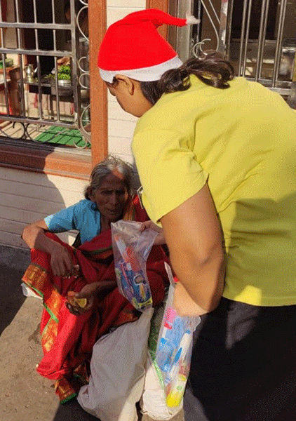 A hygiene kit being given to an elderly woman.