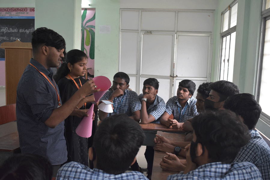 Rotaractors give a demonstration at science project in a government school.