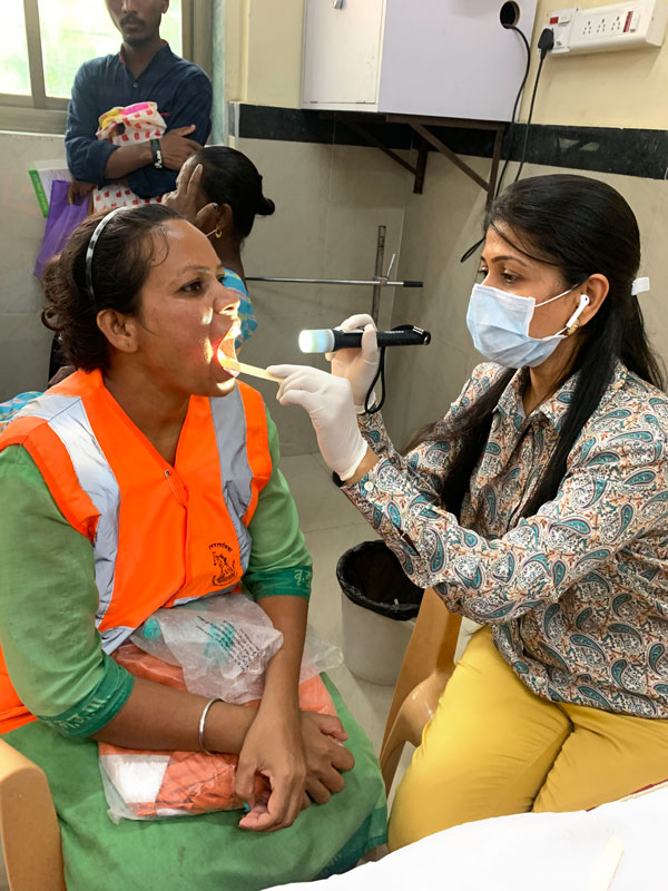  Dr Nilam Gada, president, RC Addiction Prevention in Mumbai, examines a sanitary worker.