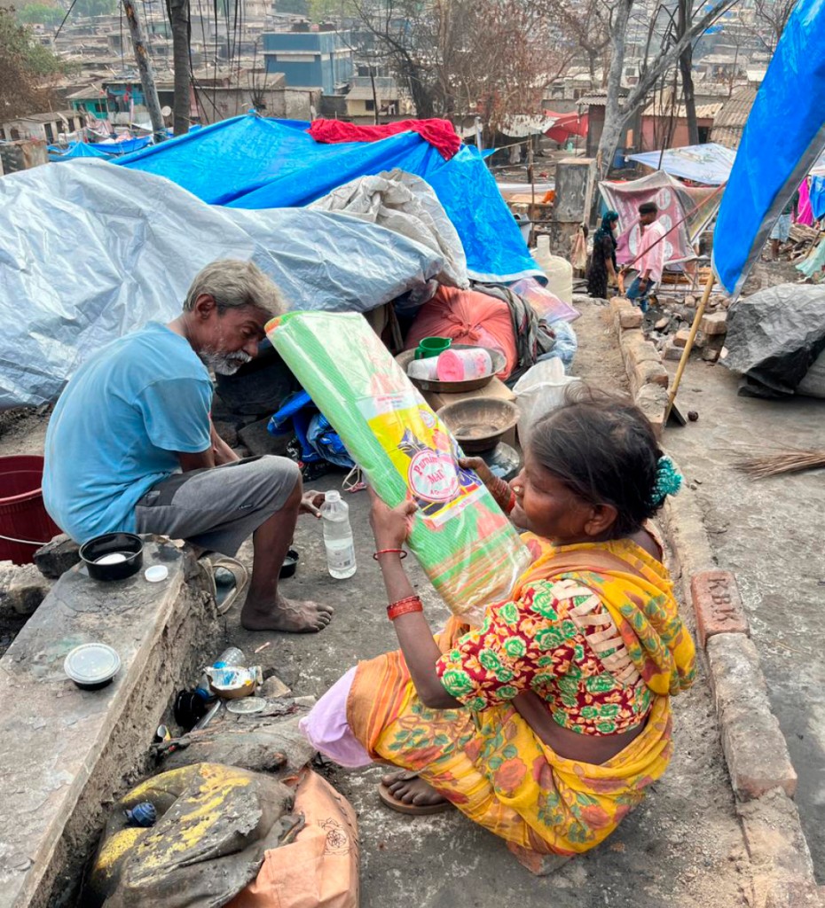 A couple with a sleeping mat given to them by the Rotaractors.