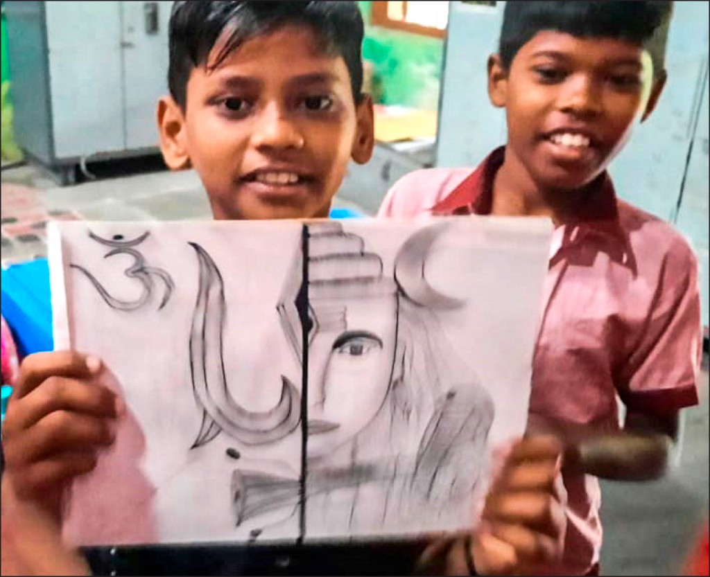 A student displays his artwork.