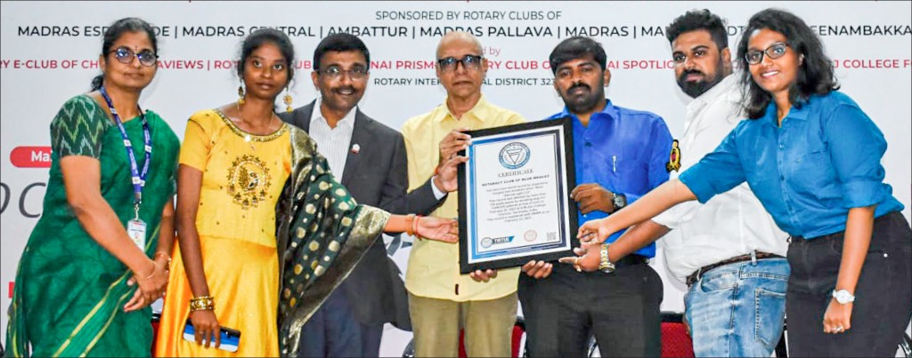 RAC Blue Whales mentor G Kamuvel (3rd from right) receives the Virtue Book of World Records certificate at the end of the hair donation campaign. A M Jain College dean M Ramya is on the left.