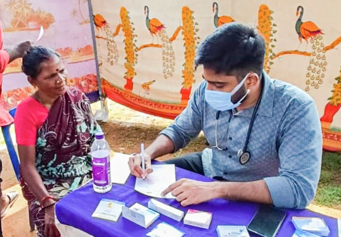 Dr Rakesh Vemparala prescribes medicines for a patient.