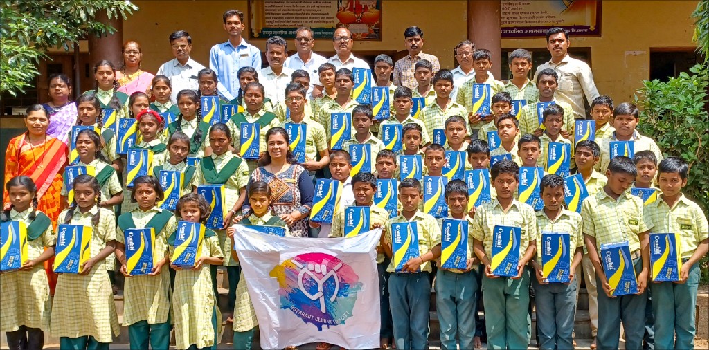Schoolchildren with the shoes gifted to them by members of RAC Karad City. Club president Akanksha Tiwari is seen at the centre (second row). 