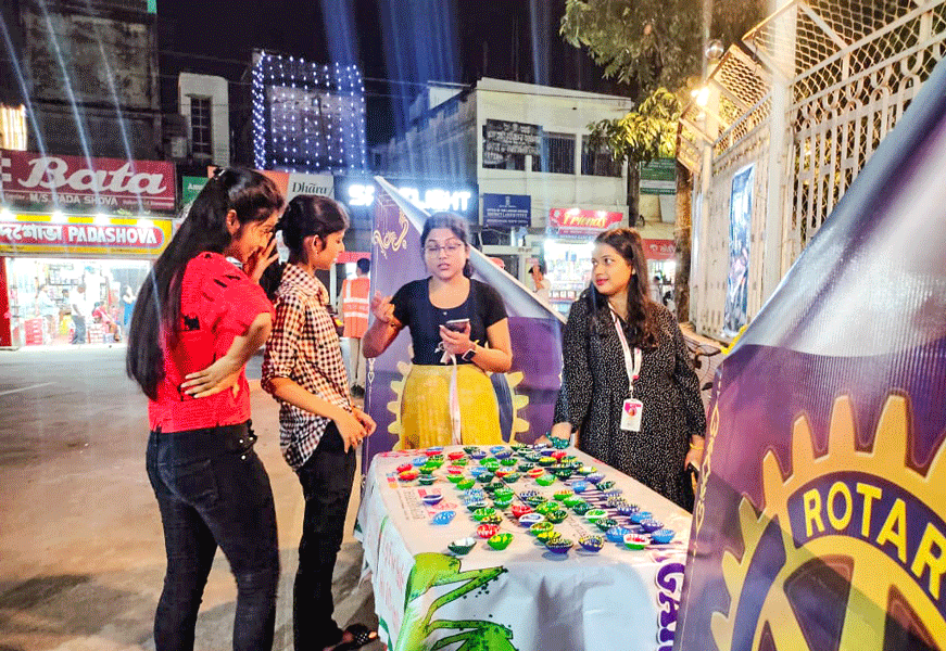 Club members interact with visitors at the stall.