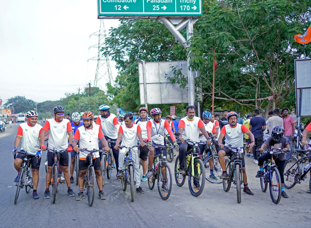 Rotaractors, along with professional cyclists, participate in a rally to promote environment protection. 
