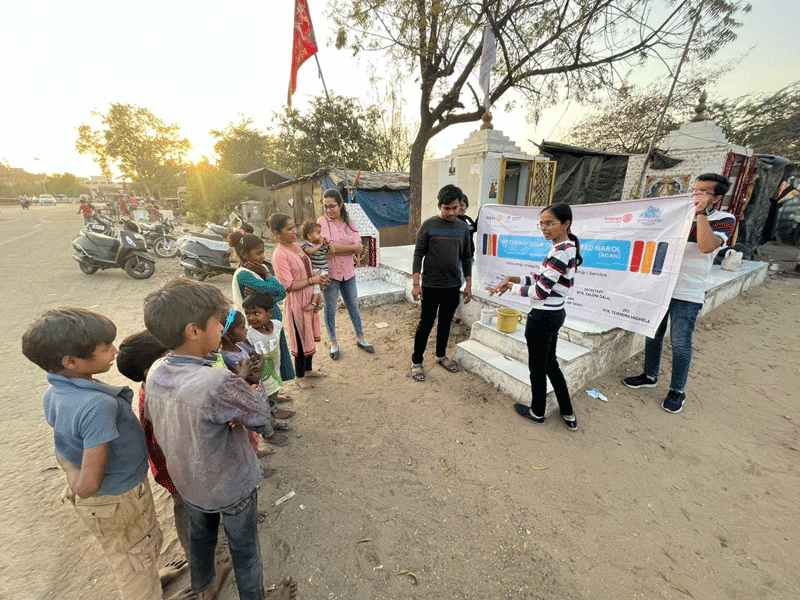 Rotaractors give a handwash demo at a slum colony.